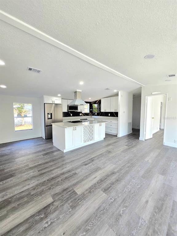 4928 Rollinglen Loop East Lakeland, FL 33810 - Photo 26 of 44 a view of a kitchen with a sink stove cabinets and empty room
