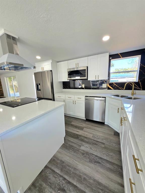 4928 Rollinglen Loop East Lakeland, FL 33810 - Photo 28 of 44 a kitchen with kitchen island a sink white cabinets and stainless steel appliances