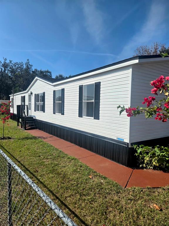 4928 Rollinglen Loop East Lakeland, FL 33810 - Photo 3 of 44 a front view of a house with a yard