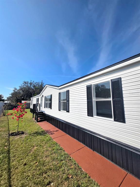 4928 Rollinglen Loop East Lakeland, FL 33810 - Photo 5 of 44 a front view of a house with a yard