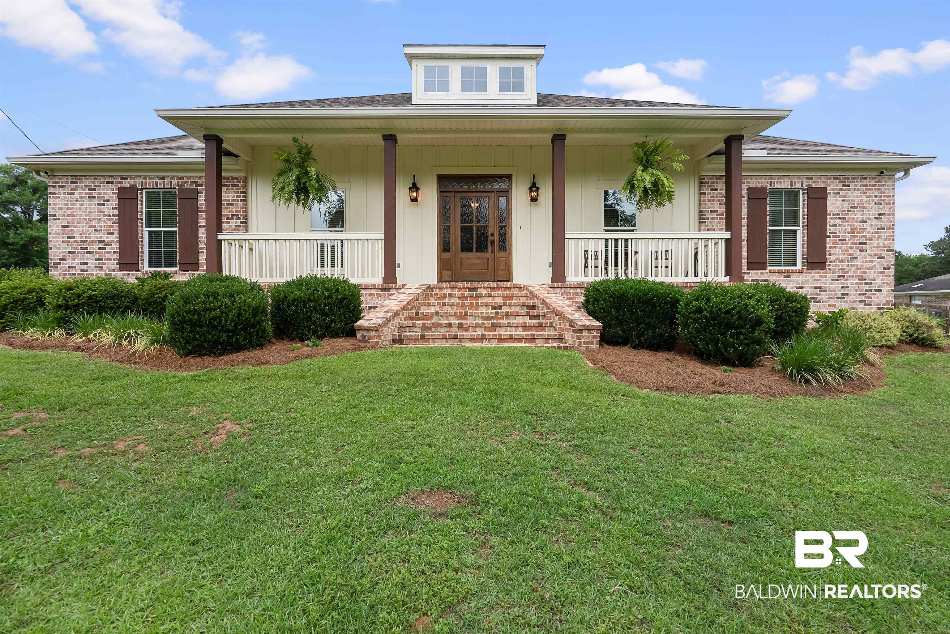 12070 Comalander Road Fairhope, AL 36532 - Photo 1 of 50 Brick exterior with dark shutters and a dormer