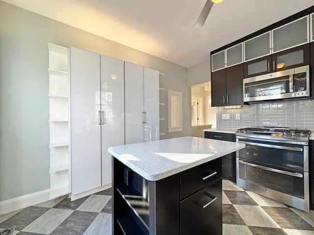 a kitchen with a table chairs and refrigerator