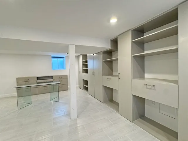 a kitchen with granite countertop a refrigerator stove top oven and sink