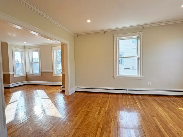 a view of an entryway with wooden floor