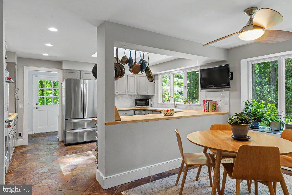 13 High Road New Hope, PA 18938 - Photo 7 of 56 a kitchen with a table chairs refrigerator and microwave
