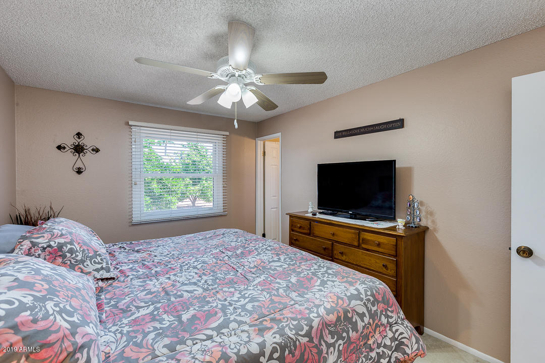 3452 East Nisbet Road Phoenix, AZ 85032 - Photo 17 of 31 a bedroom with a bed and a flat screen tv