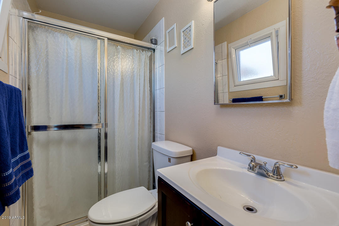 3452 East Nisbet Road Phoenix, AZ 85032 - Photo 19 of 31 a bathroom with a sink a toilet and shower