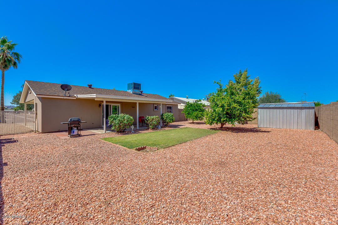 3452 East Nisbet Road Phoenix, AZ 85032 - Photo 26 of 31 a view of a house with a yard and potted plants