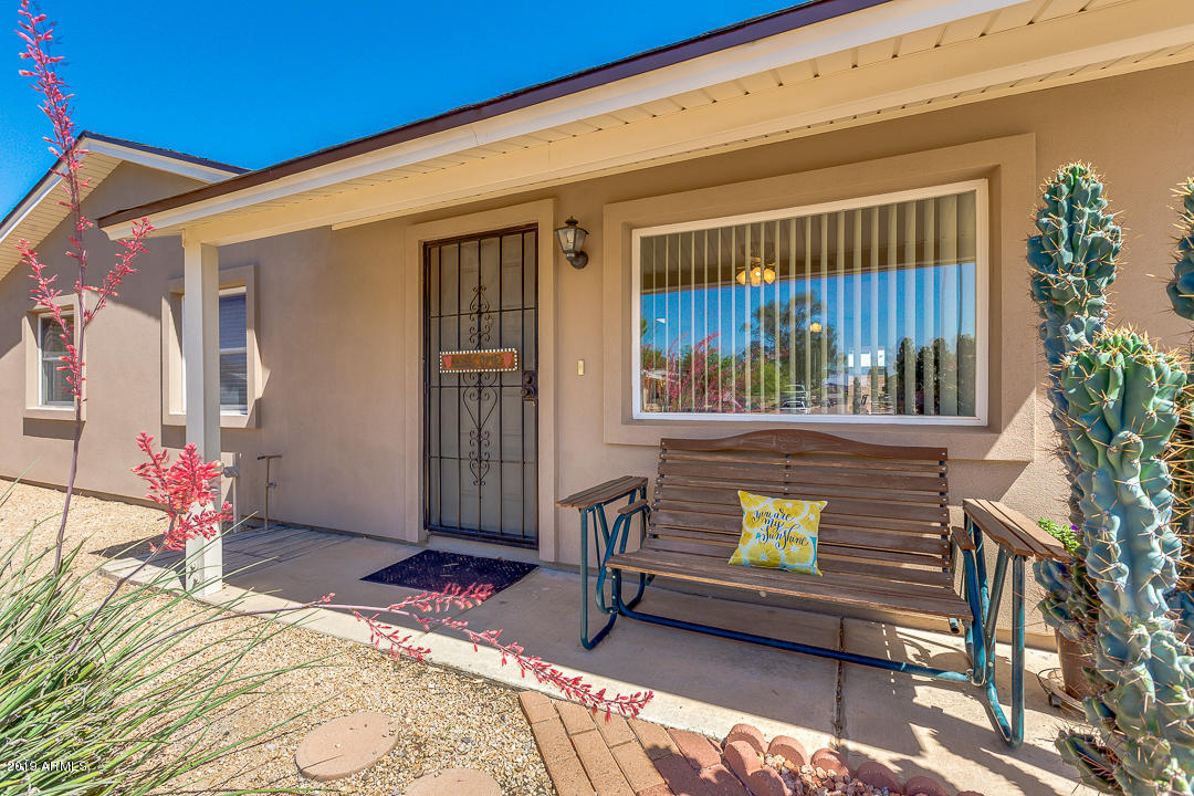 3452 East Nisbet Road Phoenix, AZ 85032 - Photo 4 of 31 a view of a porch with a bench