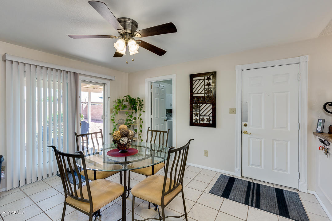 3452 East Nisbet Road Phoenix, AZ 85032 - Photo 9 of 31 a view of a dining room with furniture and chandelier