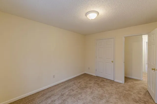 an empty room with a empty space and windows