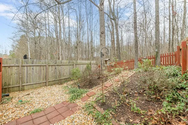 a view of a backyard with iron fence