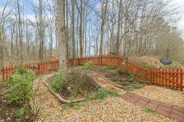 a view of a backyard with large trees