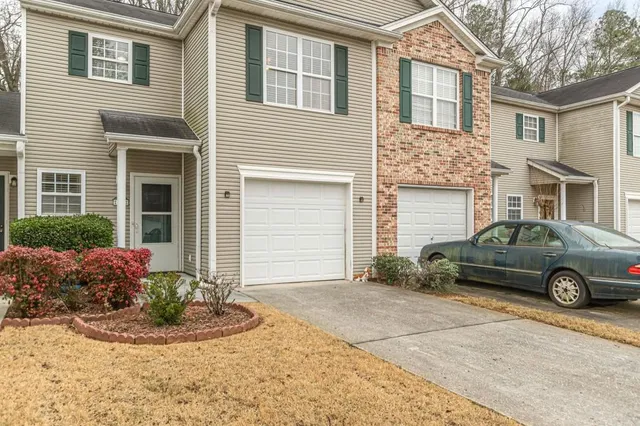 a car parked in front of white house