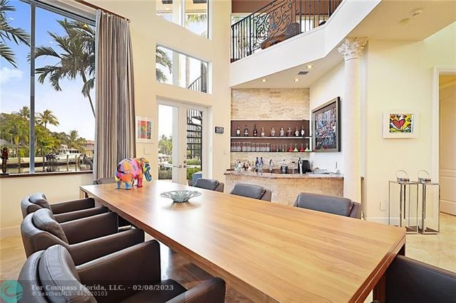 a room with furniture pool table and chairs
