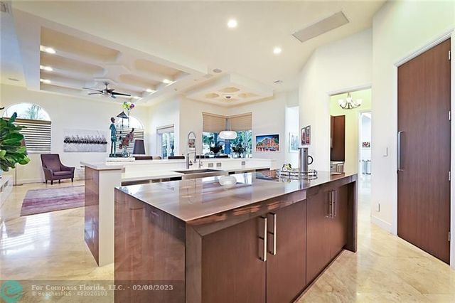 a kitchen with kitchen island a sink and a stove with wooden floor