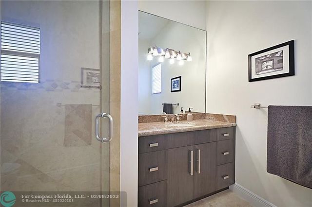a bathroom with a double vanity sink and mirror