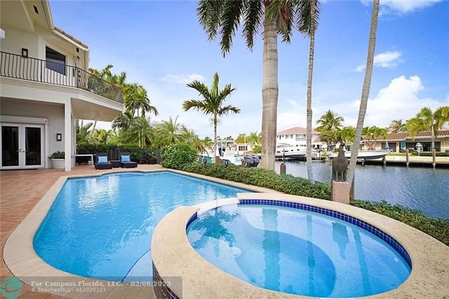 a view of a swimming pool with outdoor seating