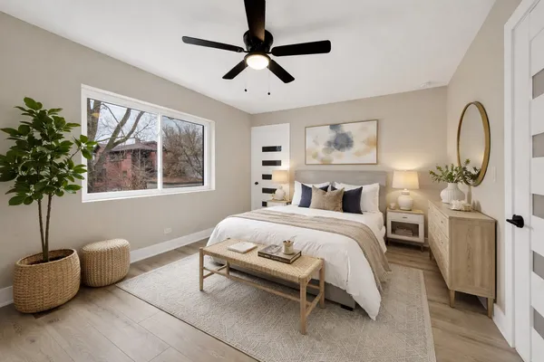 a bedroom with a bed and a potted plant