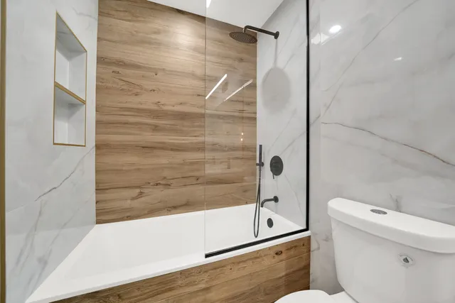 a bathroom with a shower and a toilet