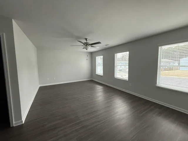 a view of wooden floor and windows in a room