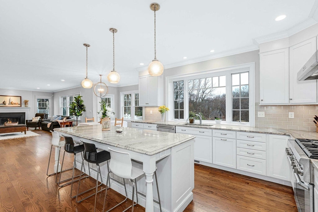 271 Monsen Road Concord, MA 01742 - Photo 20 of 42 a view of a dining table chairs and chandelier