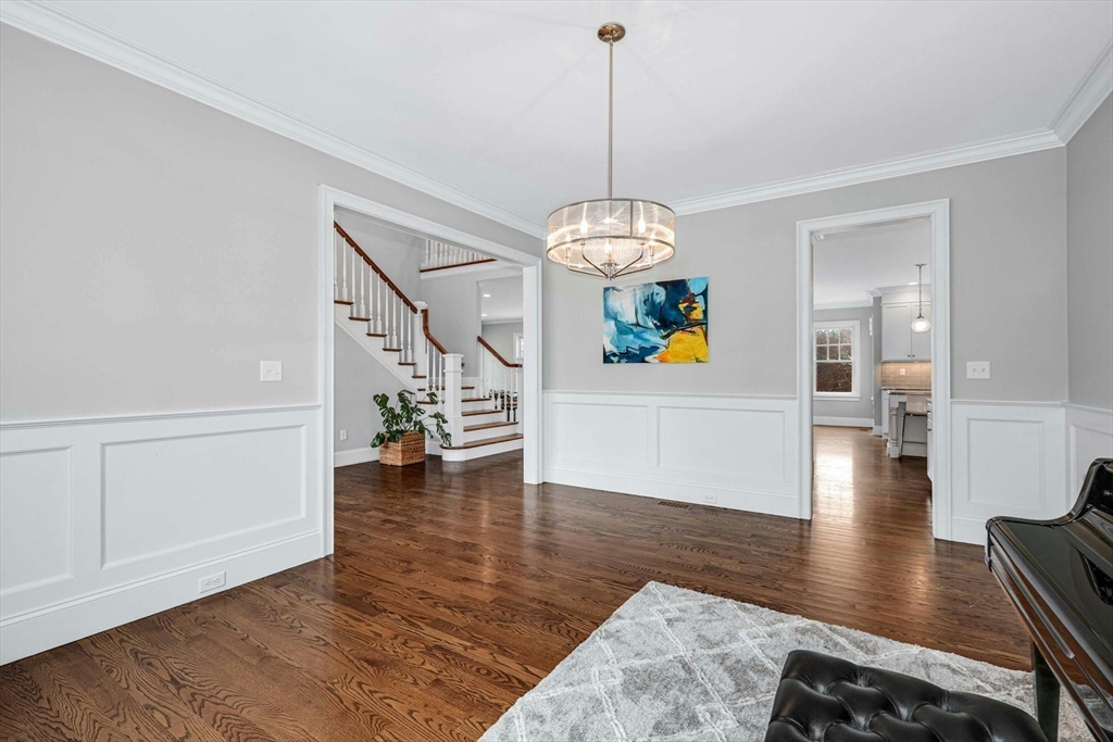 271 Monsen Road Concord, MA 01742 - Photo 8 of 42 a view of a livingroom with wooden floor stairs and a kitchen view