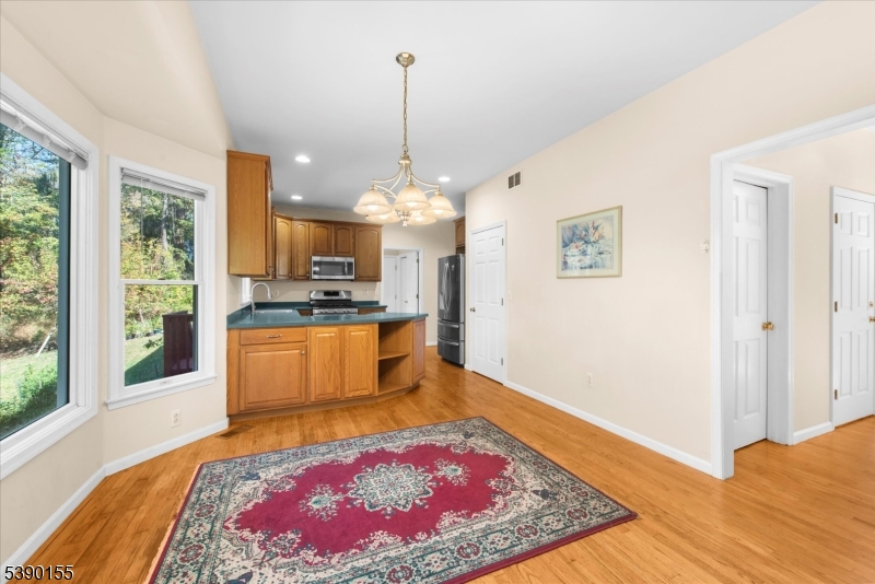 5 Sky View Garden Road Lebanon, NJ 08833 - Photo 11 of 42 a kitchen with stainless steel appliances granite countertop a stove top oven a sink dishwasher and refrigerator with wooden floor