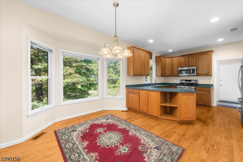 5 Sky View Garden Road Lebanon, NJ 08833 - Photo 12 of 42 a kitchen with stainless steel appliances granite countertop a stove sink and microwave