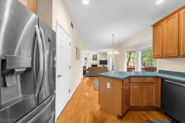 a kitchen with stainless steel appliances granite countertop a sink and a refrigerator