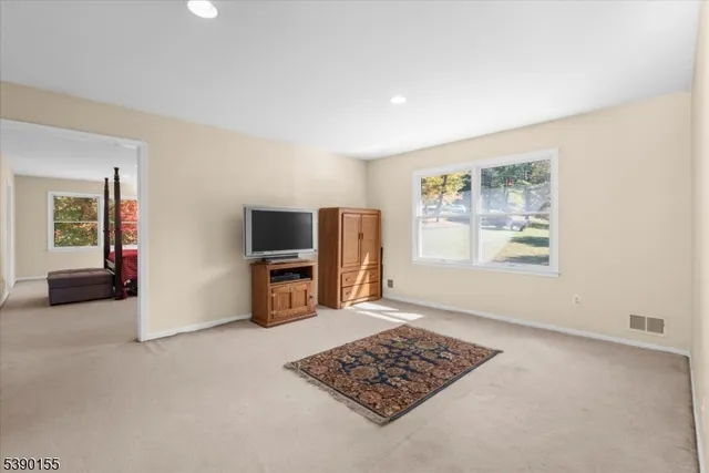 a view of livingroom with workspace and a window
