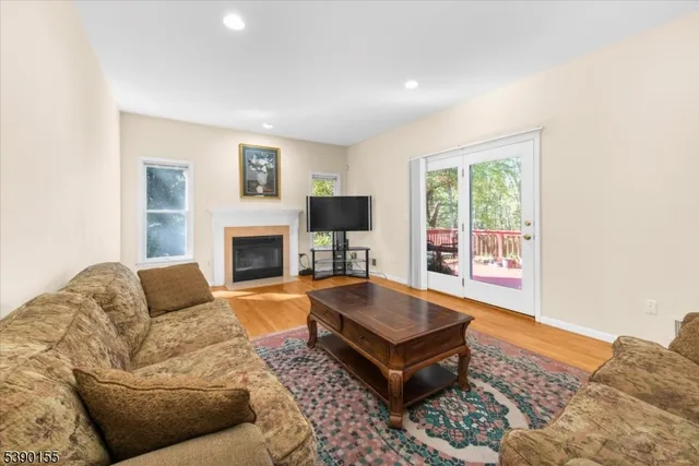 a living room with furniture fireplace and a flat screen tv