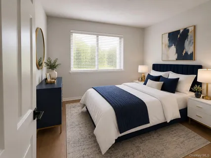 a bedroom with bed and wooden floor