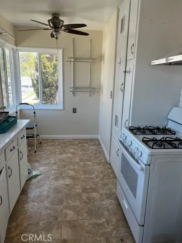 a kitchen with granite countertop a stove and a refrigerator