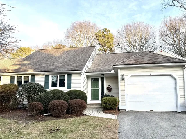 a view of a house with a yard and plants