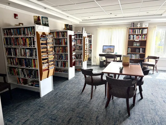a dining room with furniture and a book shelf