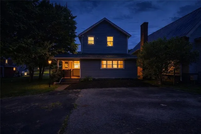 an aerial view of residential houses with outdoor space and street view