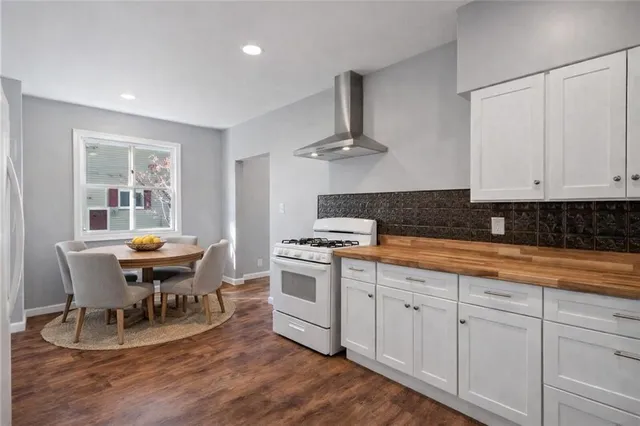a kitchen with stainless steel appliances a white wooden cabinets and stove
