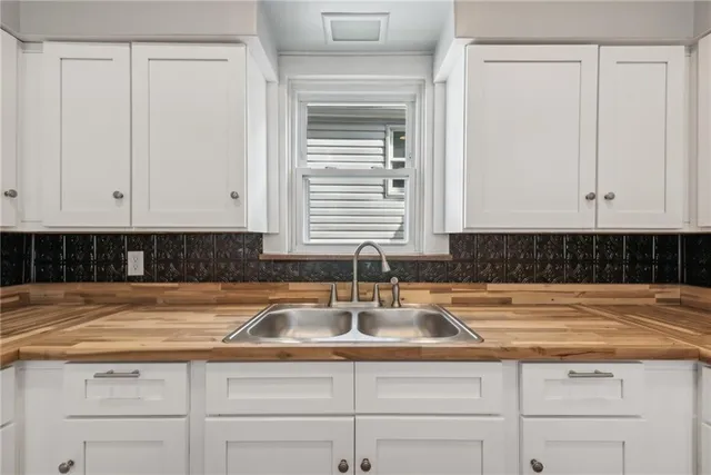 a kitchen with a sink and cabinets