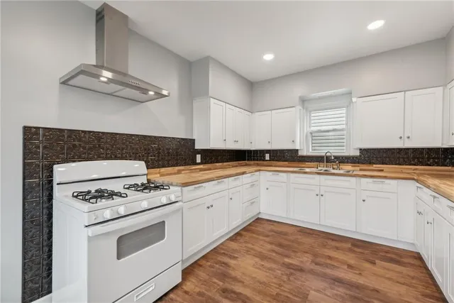 a kitchen with granite countertop stainless steel appliances sink cabinets and window