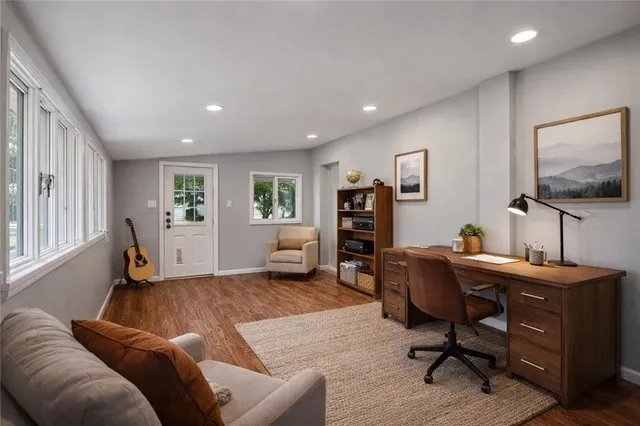 a spacious bedroom with a bed and a dresser