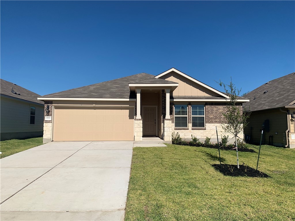 2111 Chief Street Bryan, TX 77807 - Photo 1 of 1 a front view of a house with a yard and garage