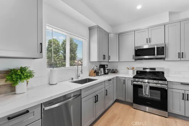 a kitchen with stainless steel appliances granite countertop a stove and a microwave