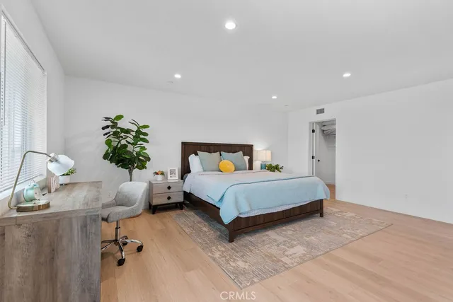 a bed room with a bed and a wall painting