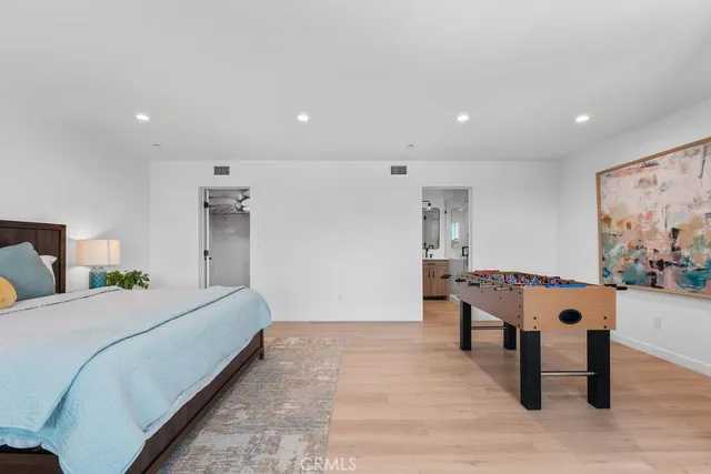 a view of a room with furniture and wooden floor