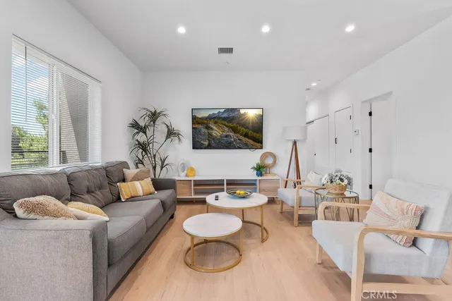 a view of a dining room with furniture and a refrigerator