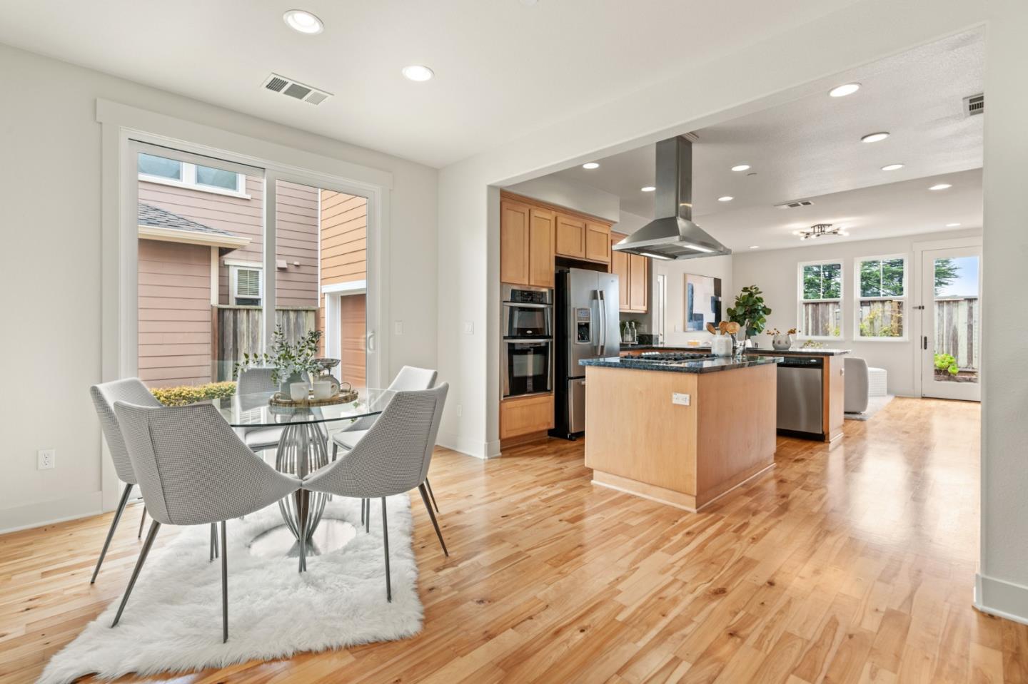 221 Bayberry Circle Pacifica, CA 94044 - Photo 13 of 63 a view of a dining room with furniture and wooden floor
