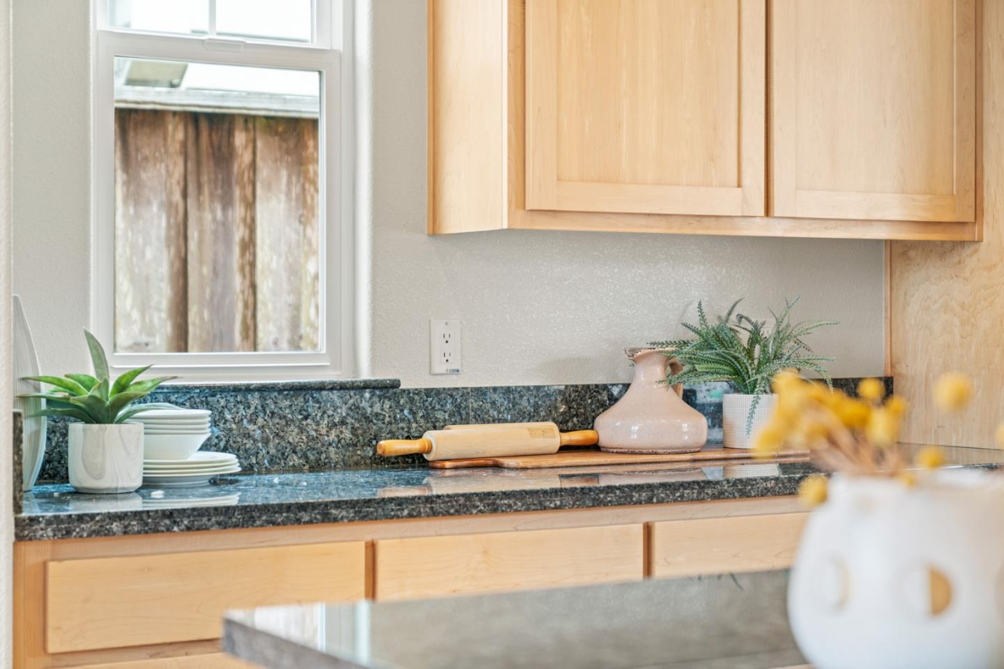 221 Bayberry Circle Pacifica, CA 94044 - Photo 16 of 63 a kitchen with granite countertop a sink a stove and cabinets