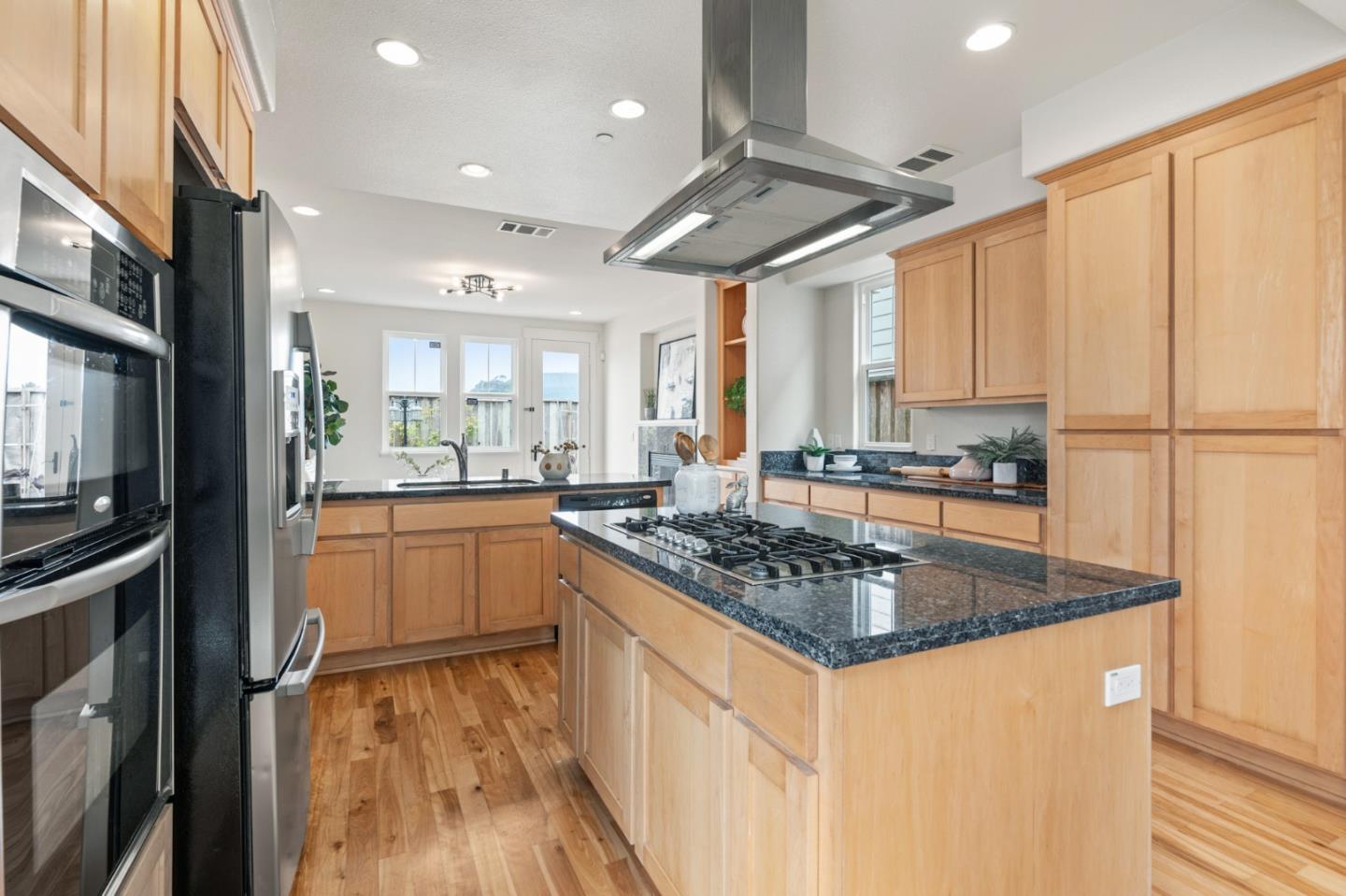 221 Bayberry Circle Pacifica, CA 94044 - Photo 20 of 63 a kitchen with stainless steel appliances granite countertop a stove a sink and a refrigerator