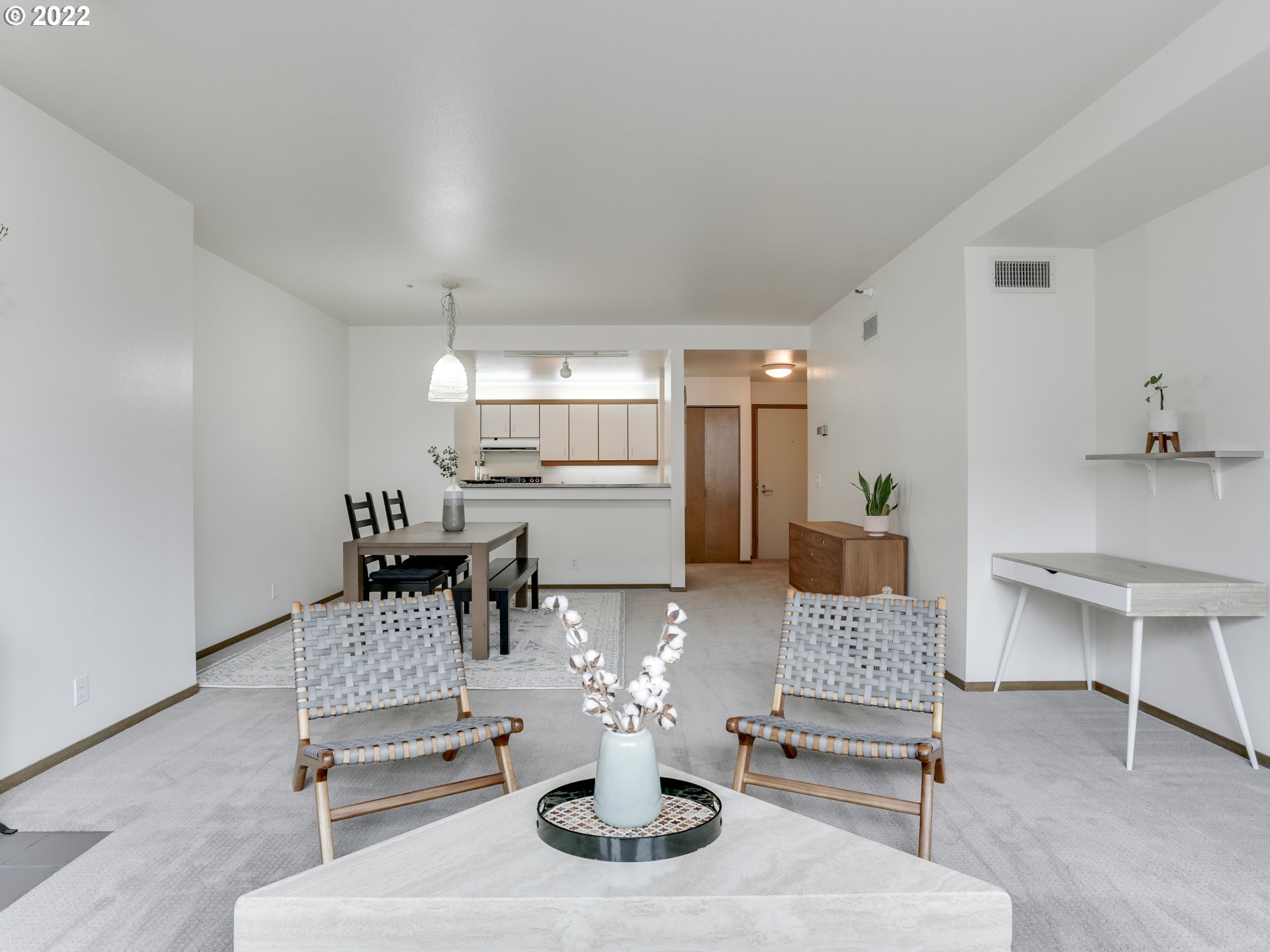 1730 South Harbor Way, Unit 405 Portland, OR 97201 - Photo 6 of 32 a living room with furniture a dining table and kitchen view